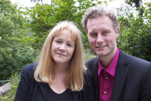 Julie & Gernot smiling portrait in park